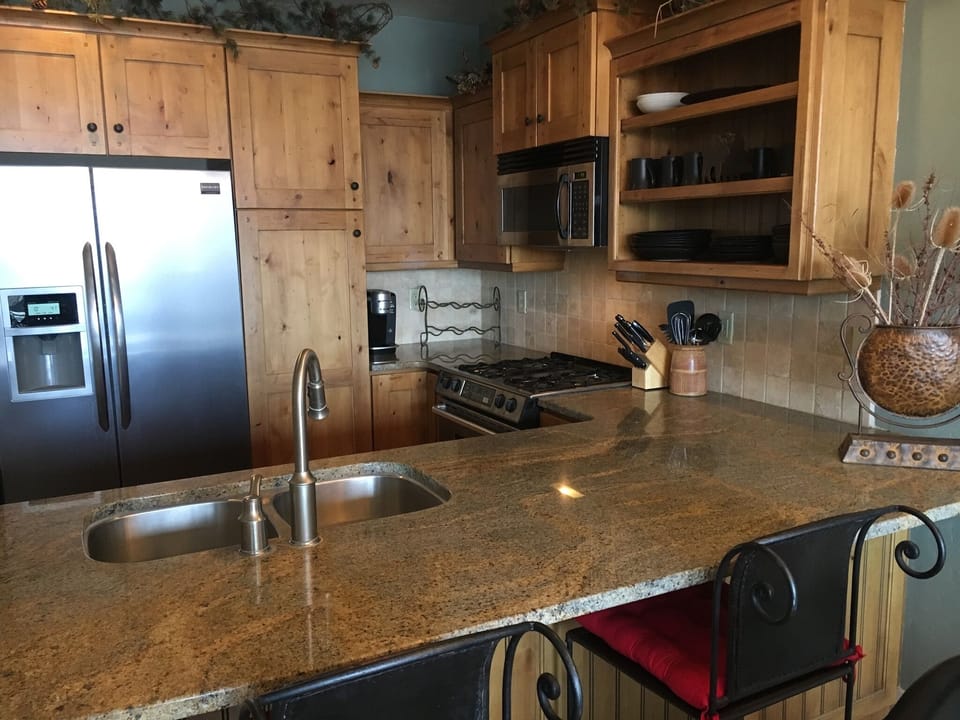 Kitchen area with alder cabinets, granite counters and stainless appliances