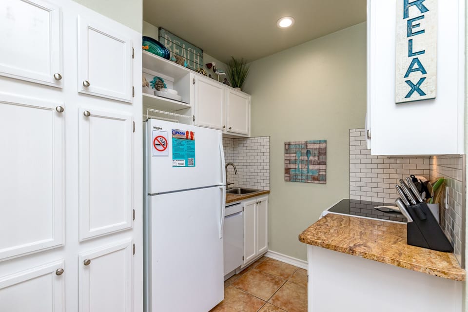 Your fully-equipped kitchen awaits with granite counters, subway tile backsplash, and everything needed to create memorable meals during your stay.