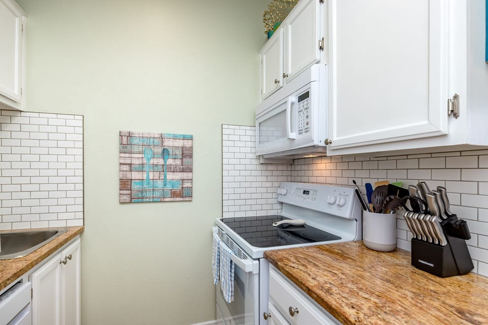 Your fully equipped kitchen features granite countertops, subway tile backsplash, and everything you need to prepare your favorite meals during your stay.
