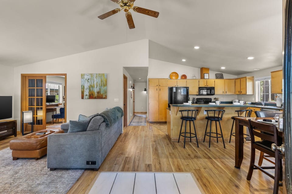 Relax in this open-plan retreat with vaulted ceilings and warm wood accents. Gather at the breakfast bar, unwind on the cozy sofa, or cook in the fully equipped kitchen.