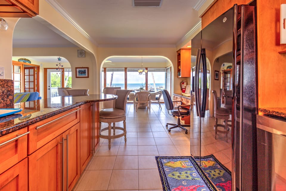 kitchen with bar and dining room water view