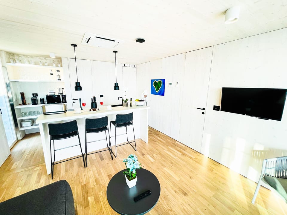 From the couch you have a great view of the kitchen, from where you can see the modern equipment.