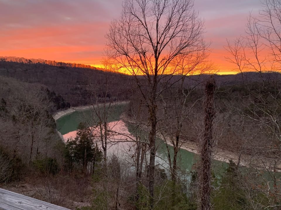 Sunrise over the water and mountains 