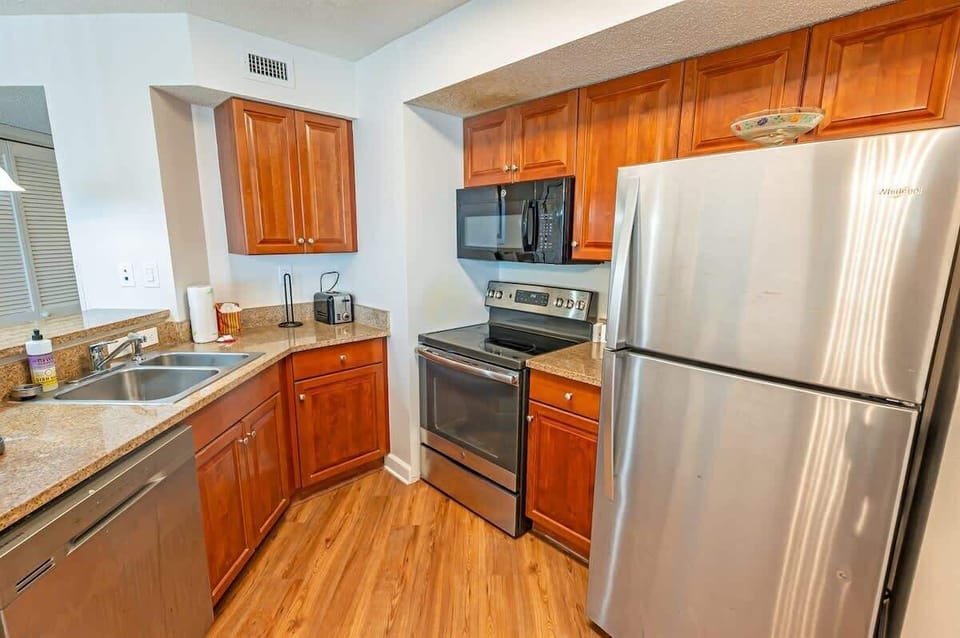 - Fully equipped kitchen with stainless steel appliances   - Granite countertops and wooden cabinets add charm   - Cook family meals with oven, stove, fridge, and more