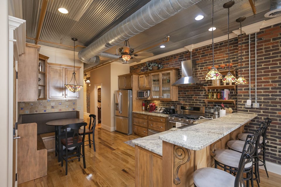 - Nashville kitchen with brick accents and stainless appliances   - Granite island seating and stylish lighting for shared meals   - Fully equipped space ideal for group cooking and gatherings