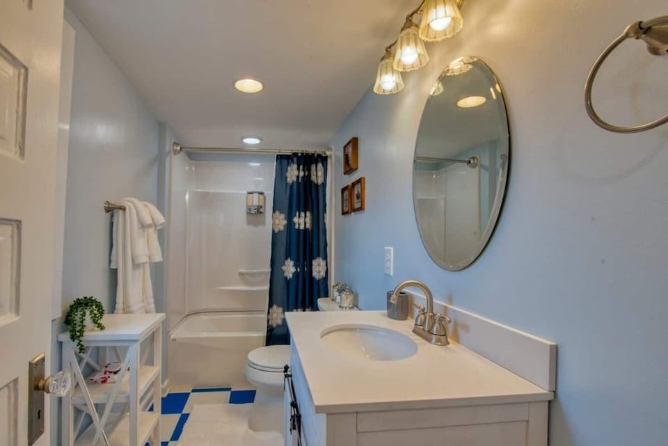 The inviting bathroom comes with a low bath and a shower.