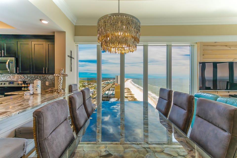 Dining Table, Chandelier, Penthouse View, Kitchen, Flat Screen TV.