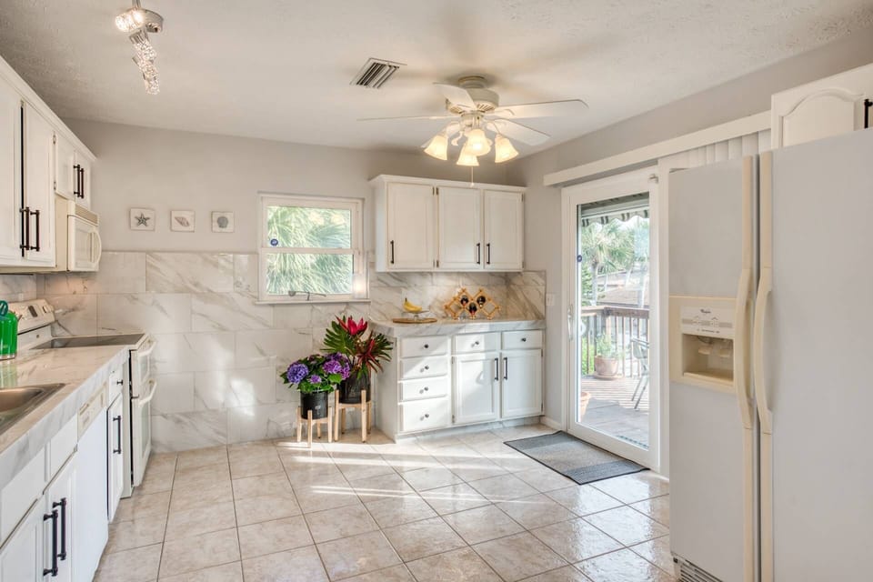 Bright beautiful kitchen with plenty of space for cooking and fellowship.