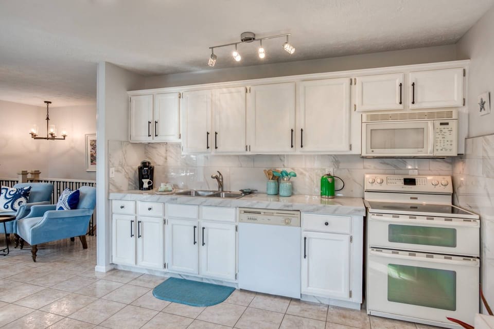 The kitchen is fully equipped with dishwasher, stove, oven and microwave.