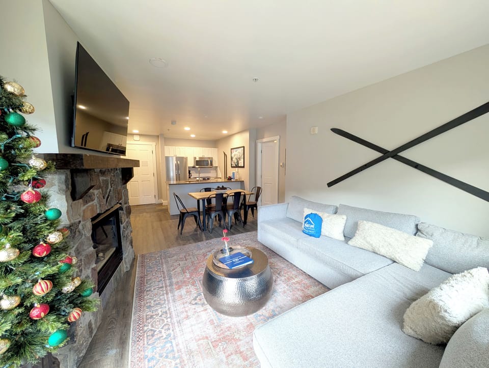 Relax in your open-concept living space with plush sectional seating, cozy fireplace, and large flat screen tv