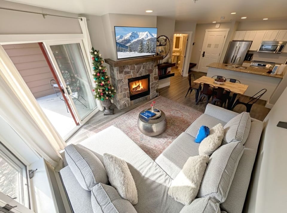 Sink into plush seating by your crackling fireplace, where snowy peaks on the big screen mirror winter views outside your door.