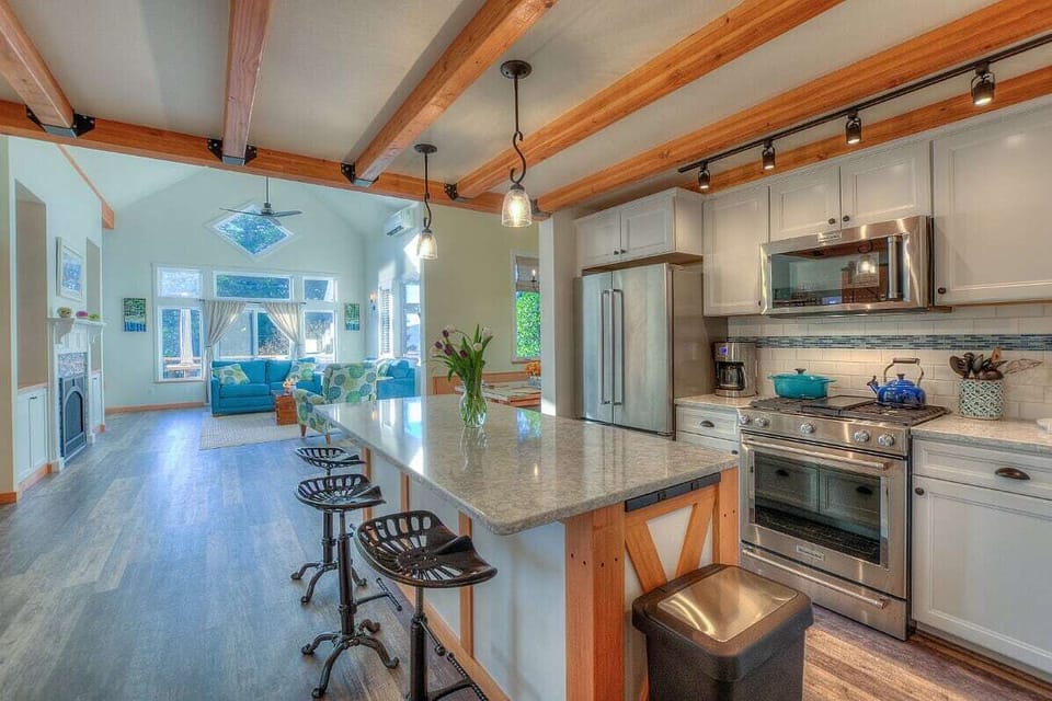 Chef's Kitchen into Living Room Area with Vaulted Ceilings