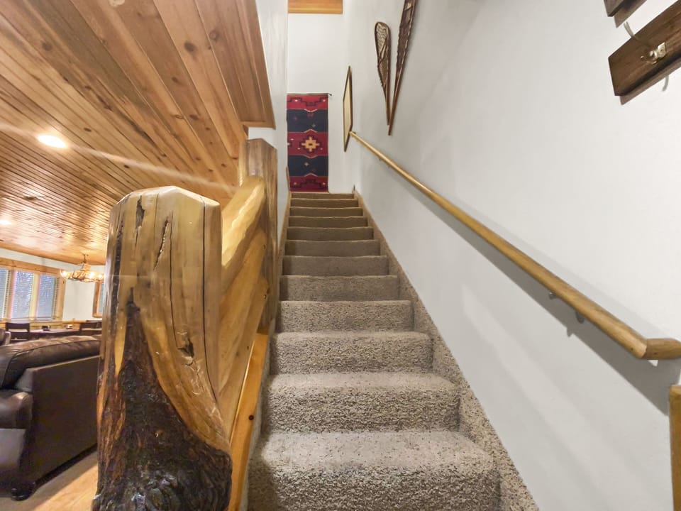 Ascend our beautifully crafted log staircase to the upper level living areas. Rustic charm and easy access to all the cabin's great amenities.