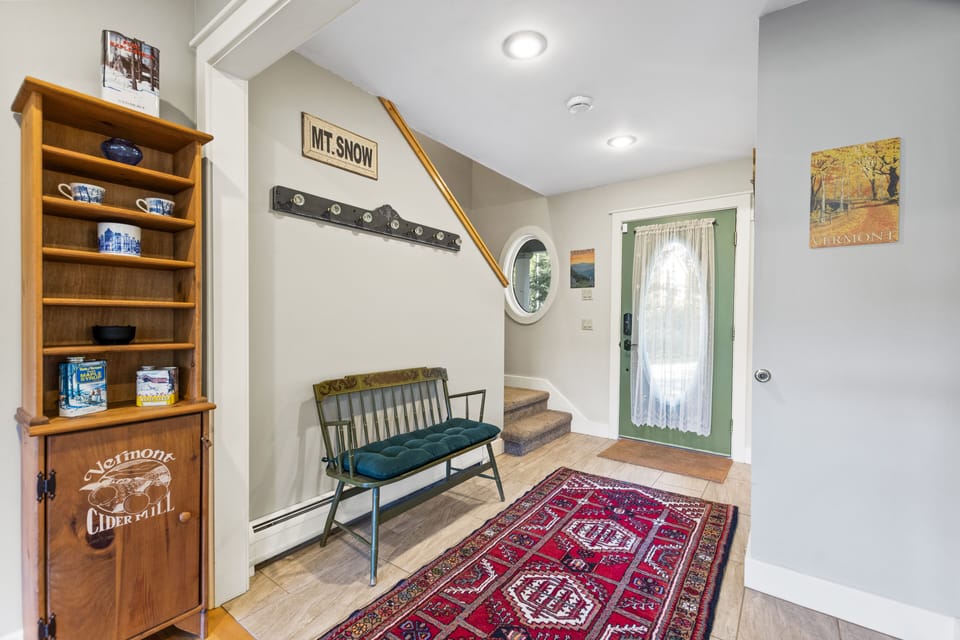 Welcoming front entry. Rugs were replaced since photo was taken.