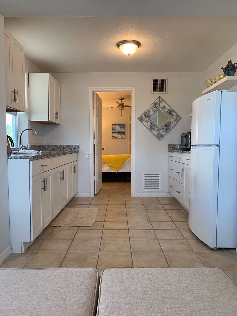 This is both sides of the kitchen with a view into the bedroom.