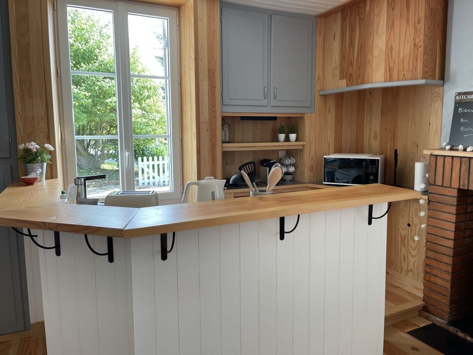 A light functional kitchen area that is fully equipped.