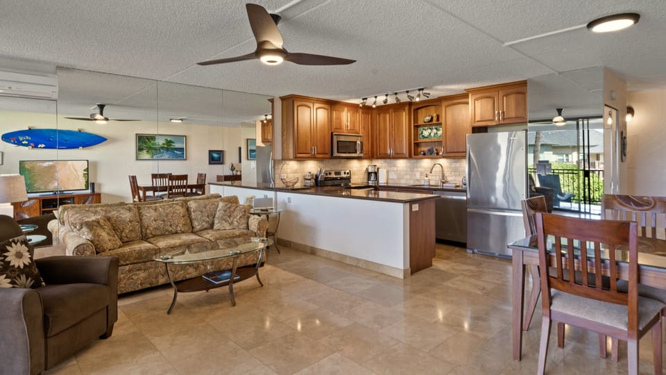 Recliner, sofa and beautiful fully stocked kitchen.
