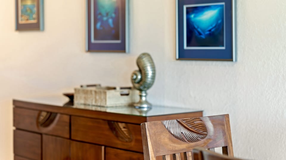 Palm frond carvings in the mahogany chairs.