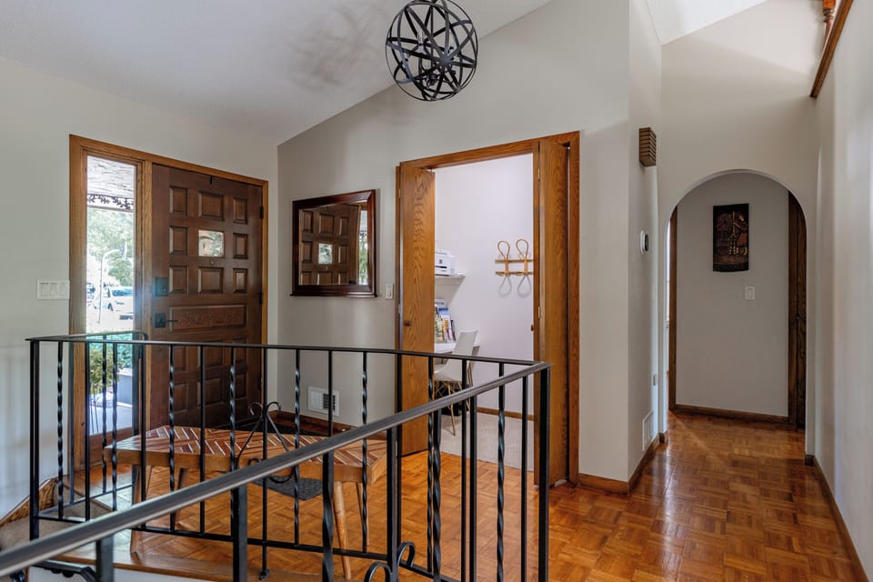 A spacious closet that serves as a workspace with desk light ring and printer.
