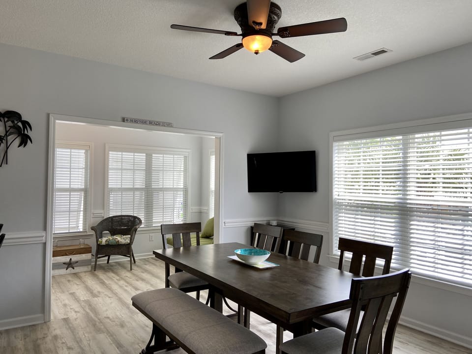Dining area off kitchen leads into sunroom and back door to pool.