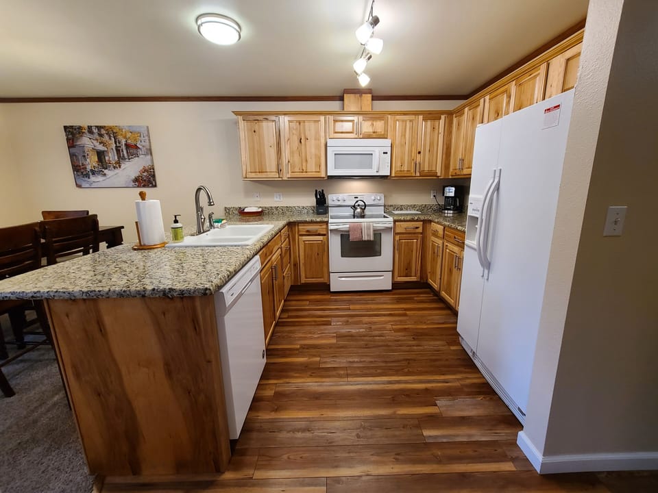Full kitchen with hickory cabinets and granite countertop.