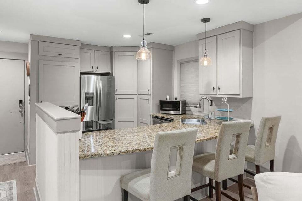 The kitchen has granite countertops, stainless steel appliances, and an abundance of cooking amenities.
