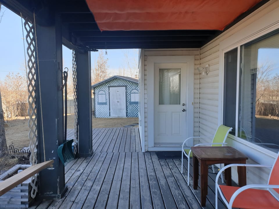 Self checking- in door and covered patio with outdoor sitting. 