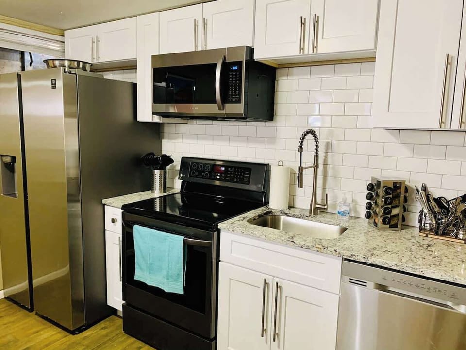 Kitchen fully equipped with appliances, cookware, tableware, cutlery and a stocked Keurig