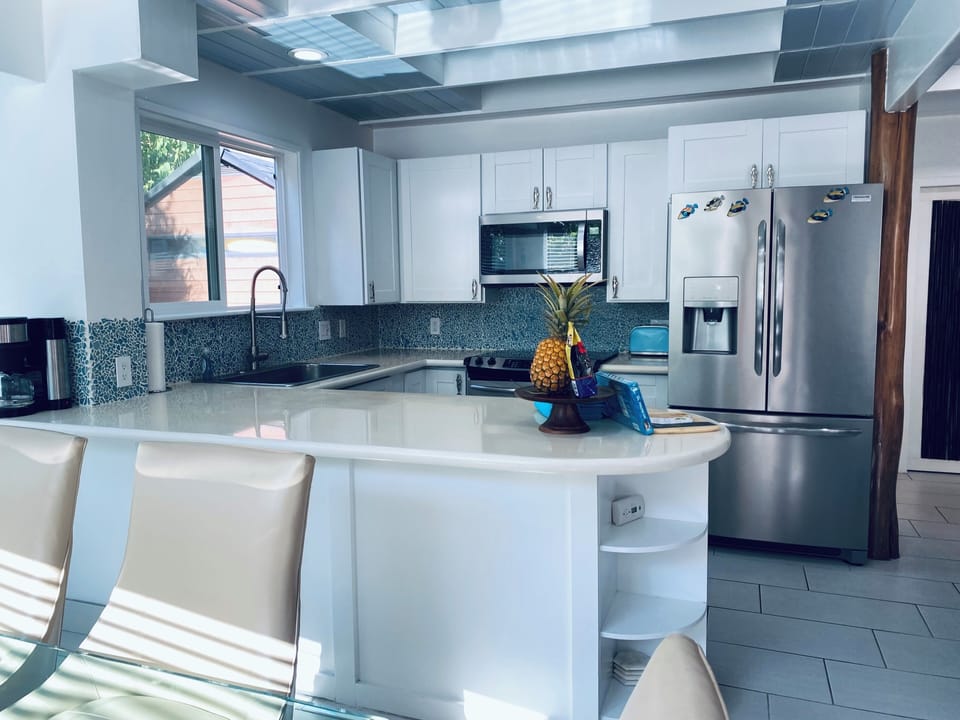 Open Kitchen Concept with Stainless Steel Appliances. 