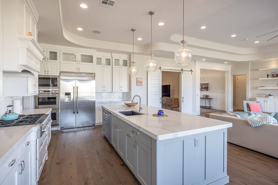 Kitchen Side View - Side view of kitchen showing off the beautiful counter tops and stainless-steel appliances.