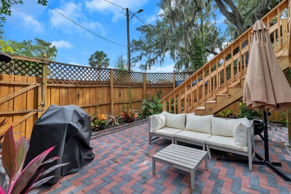 Enjoy the shared backyard - incredibly cute with gardens, pavers, and draped with spanish moss! 