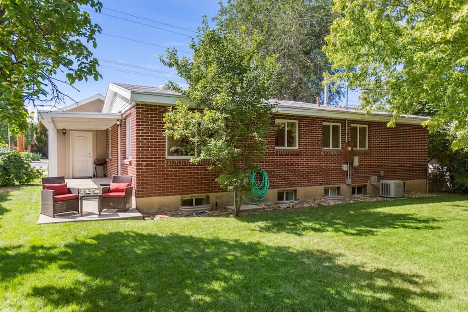 View of backyard, patio furniture and back of the house.