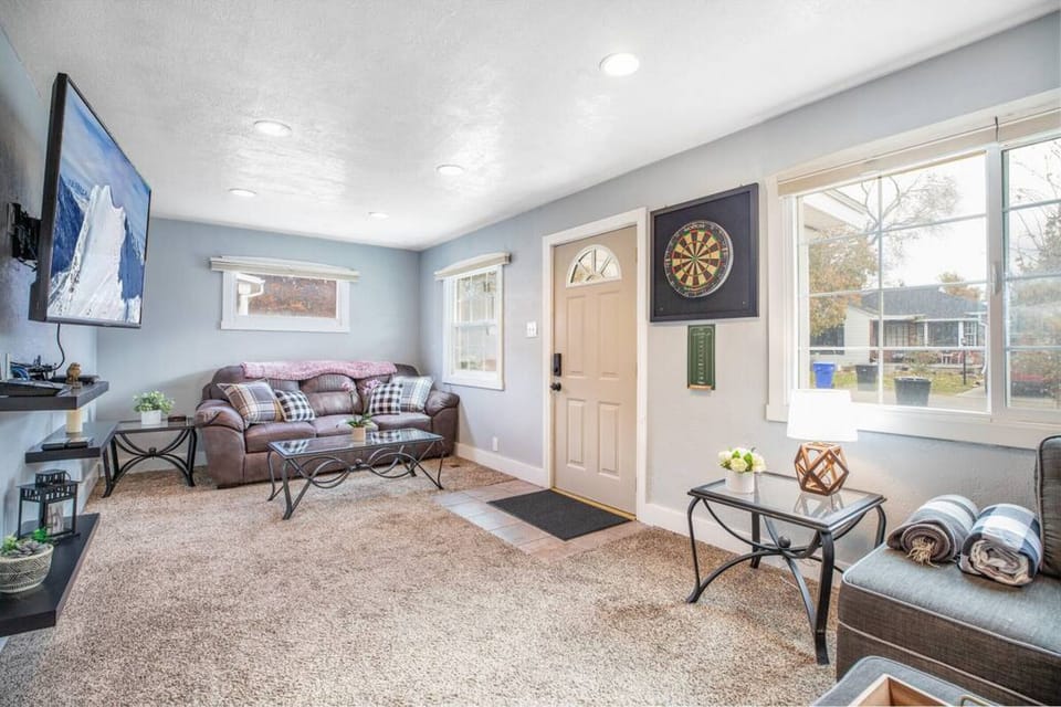 Enjoy a cozy living room with a TV and plenty of plush pillows.