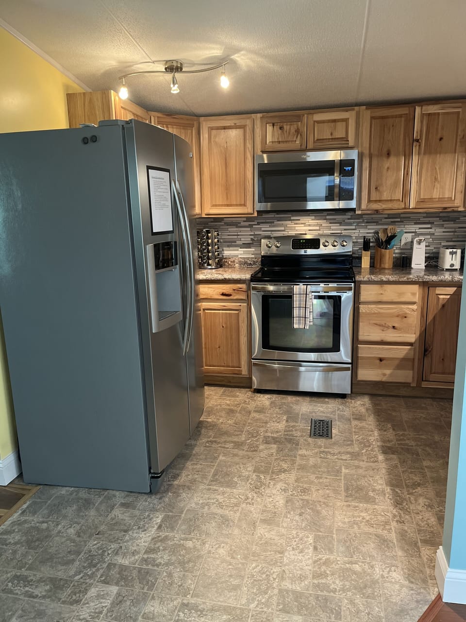 Kitchen is updated with stainless appliances, new cabinets, backsplash & counter