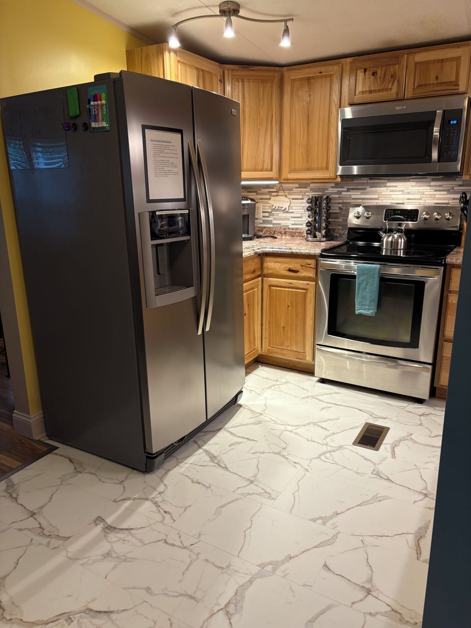 Kitchen is updated with new flooring, and stainless appliances.