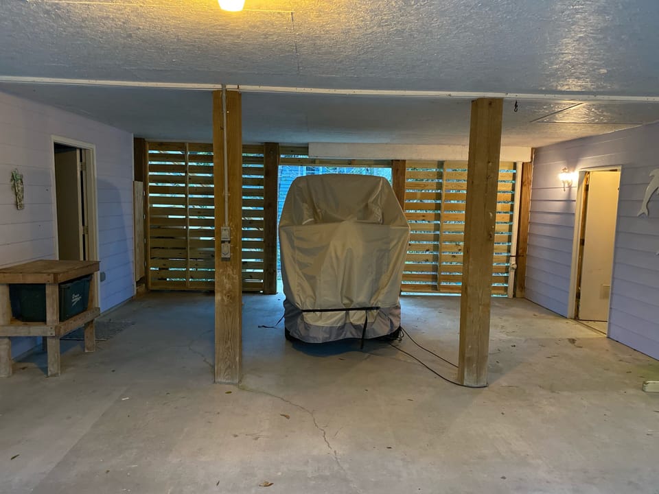 Left side of the carport beside "Toy Room" and storage room.