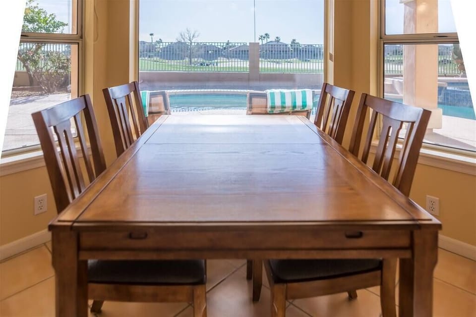 Breakfast room overlooking backyard swimming pool and golf course