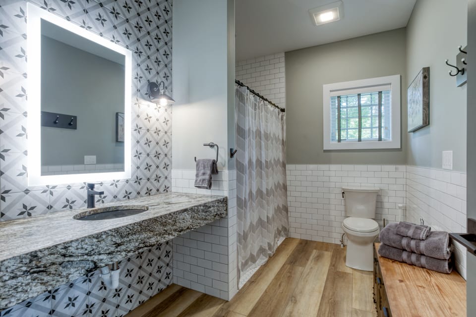 Main Level Bathroom w/ shower. Adjacent to King Bedroom #1. 
