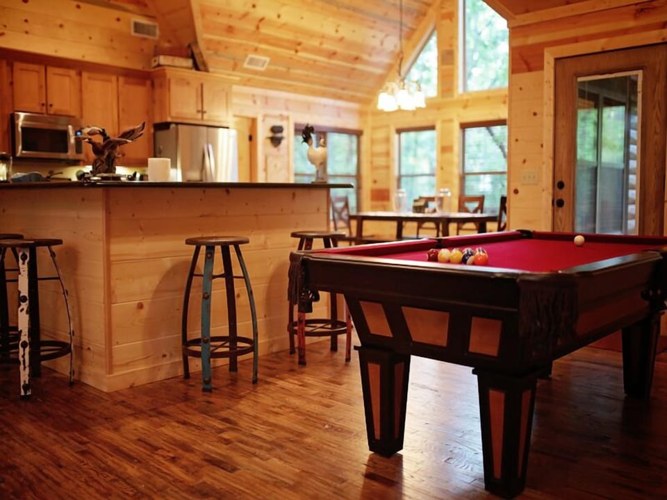 Pool table fun in this bright, open-concept cabin space