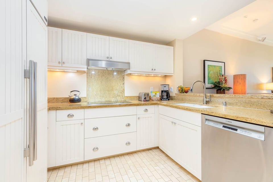 Prepare delicious meals in the modern kitchen with granite countertops and all the essentials for easy cooking.