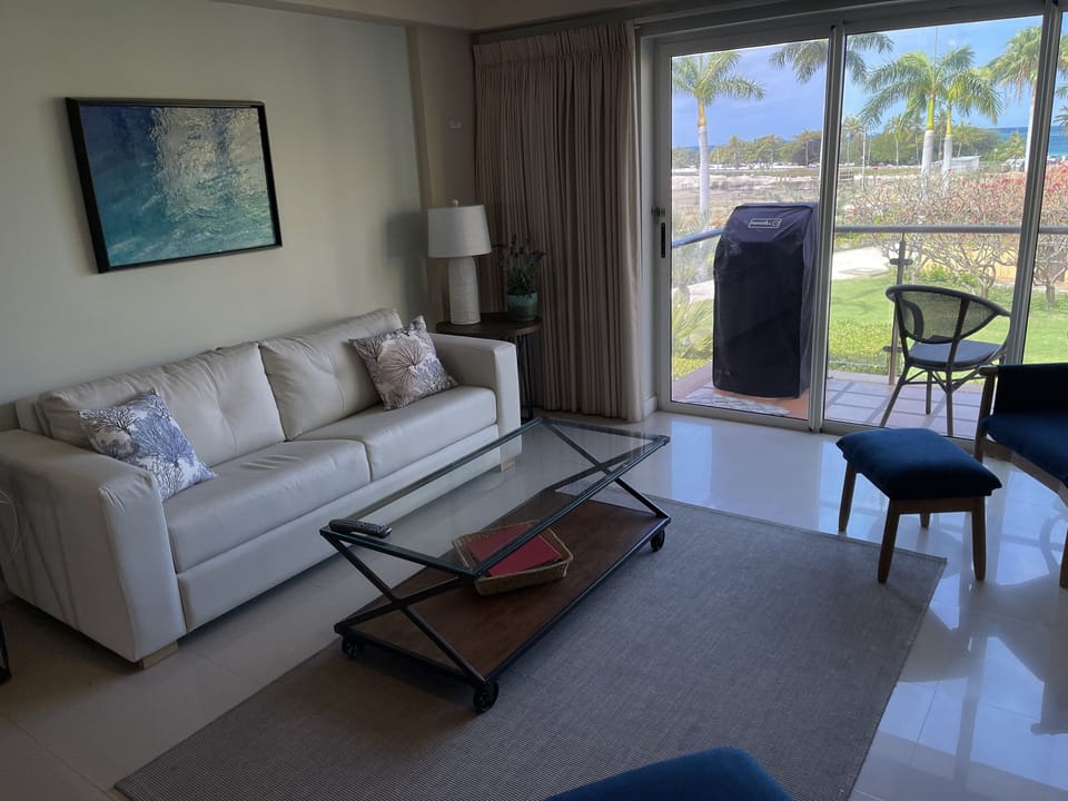 Updated living room with ocean views and 50” TV.