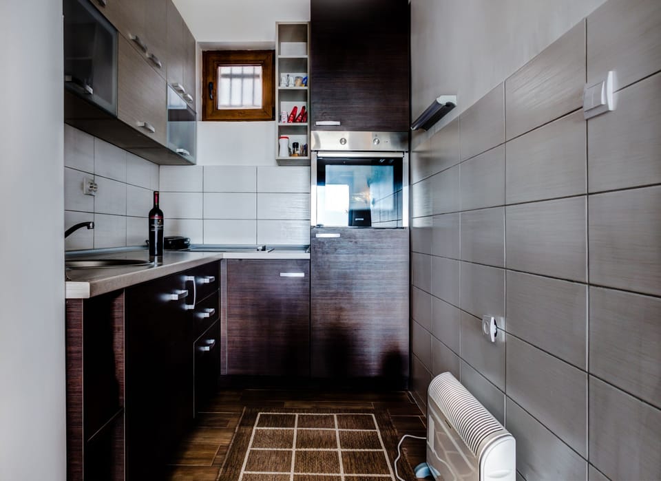 Fully equipped kitchen with modern utensils and appliances.