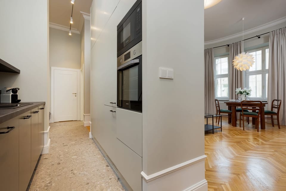 A connecting hallway showing a glimpse of the kitchen and dining area, emphasizing the modern layout.