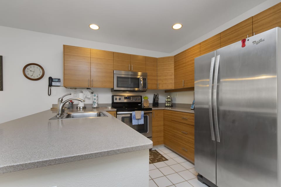 Your fully equipped kitchen features modern appliances, warm wood cabinetry, and generous counter space—perfect for preparing meals and enjoying the comforts of home during your stay.
