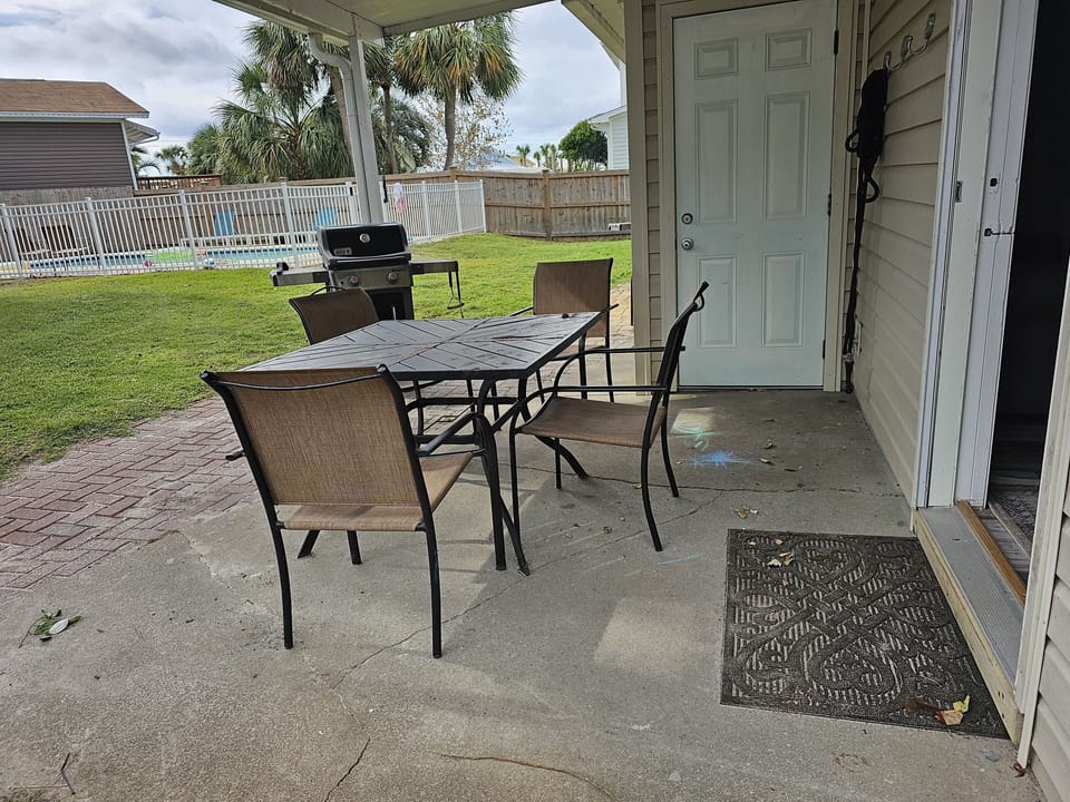 private patio with bbq grill facing the pool