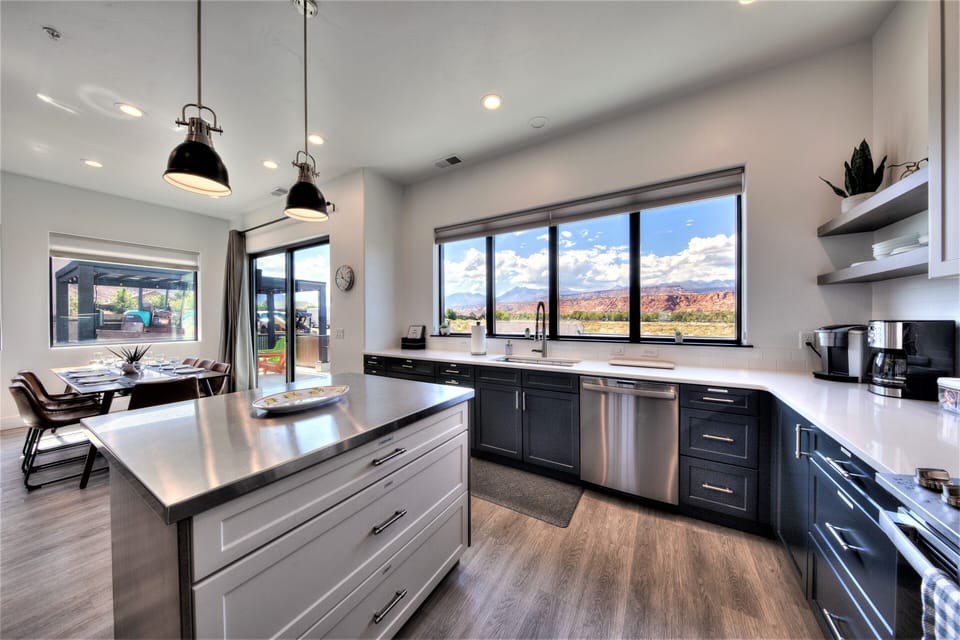 Large open kitchen with stainless steel island showing the beautiful views.