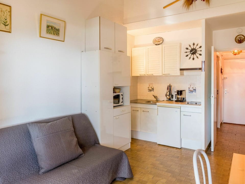 Furniture, Cabinetry, Picture Frame, Wood, Interior Design, Comfort, Home Appliance, Floor, Living Room, Ceiling Fan