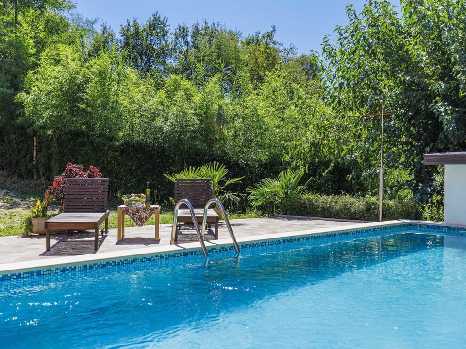 Water, Plant, Sky, Swimming Pool, Tree, Shade, Natural Landscape, Outdoor Furniture, Leisure, Grass
