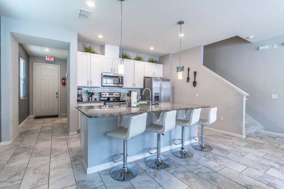 Stainless Steel Appliances and Granite Counter Tops Grace This Spacious Kitchen