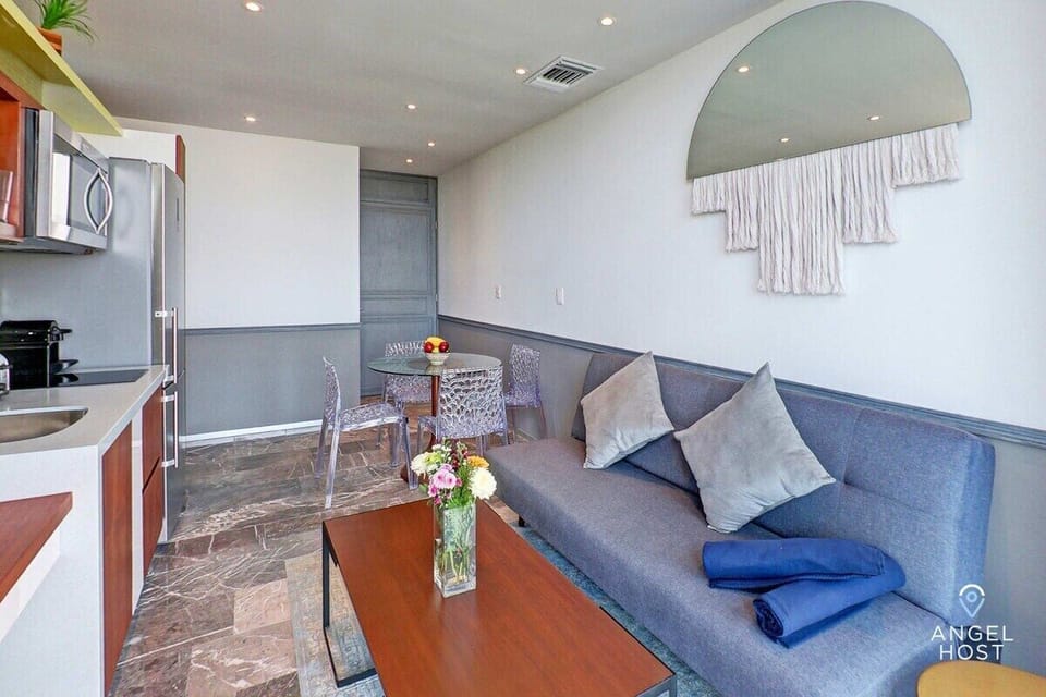 Living room has a queen sofa-bed pullout, TV, and coffee table